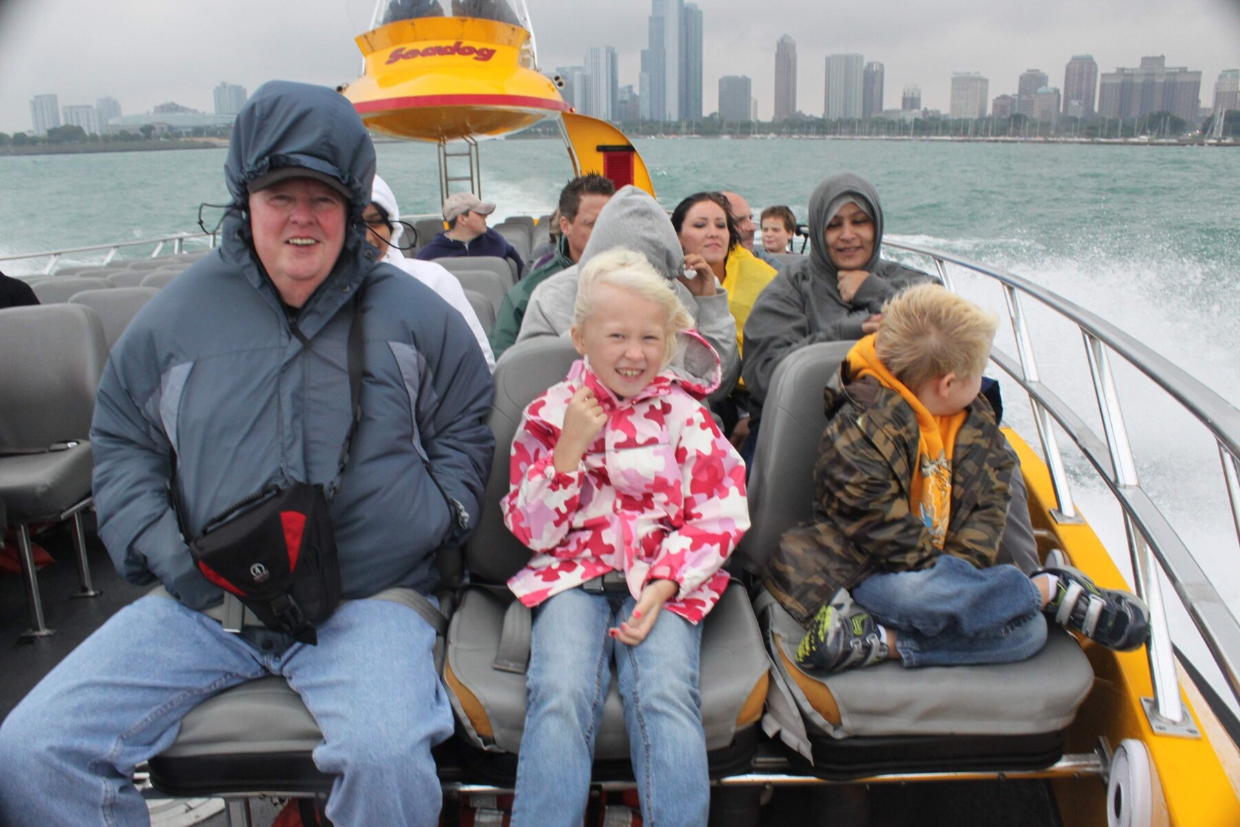 Tom Snyder riding on a speedboat with young family members