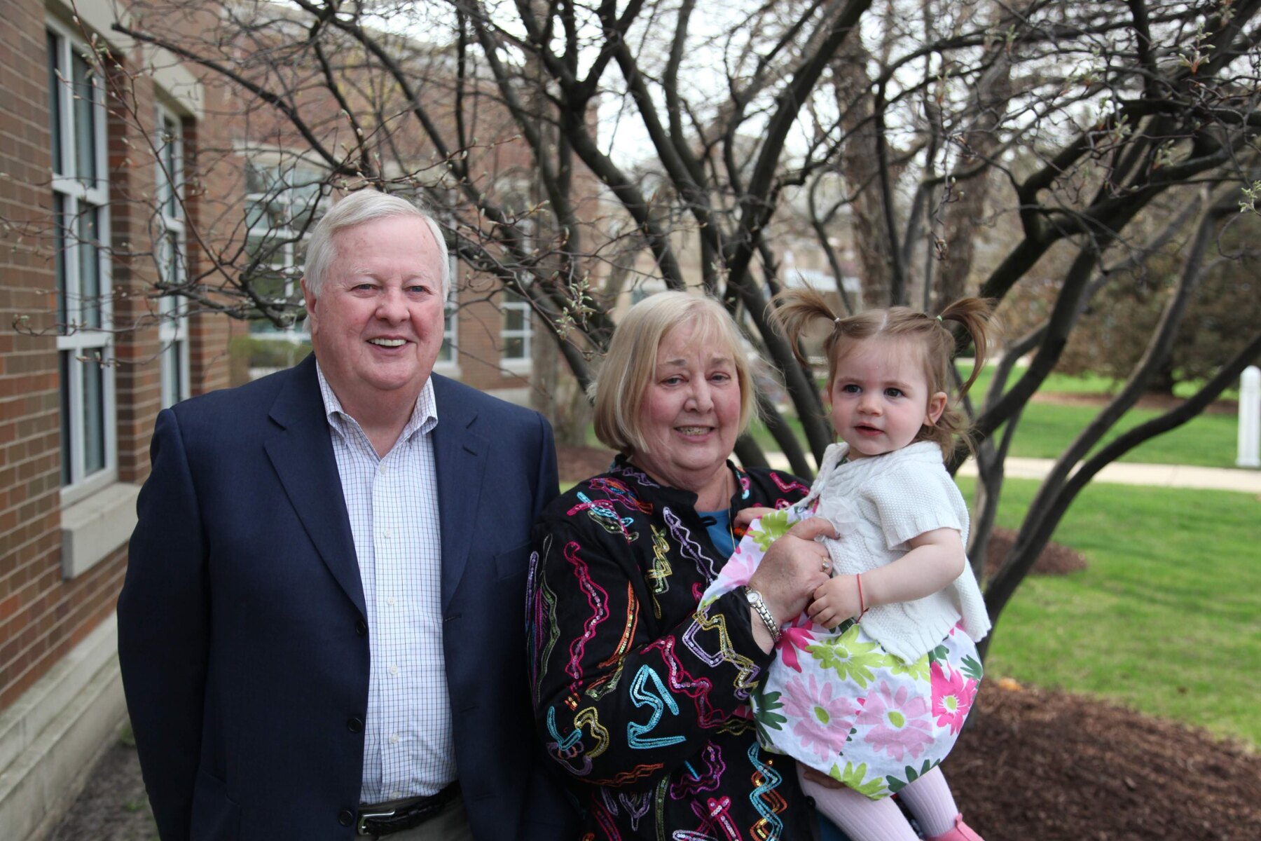 Tom and Ann Snyder with a young family member