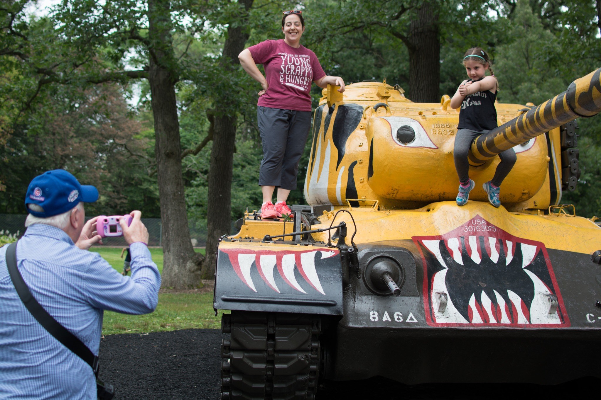 Tom taking a photo of family on a painted tank