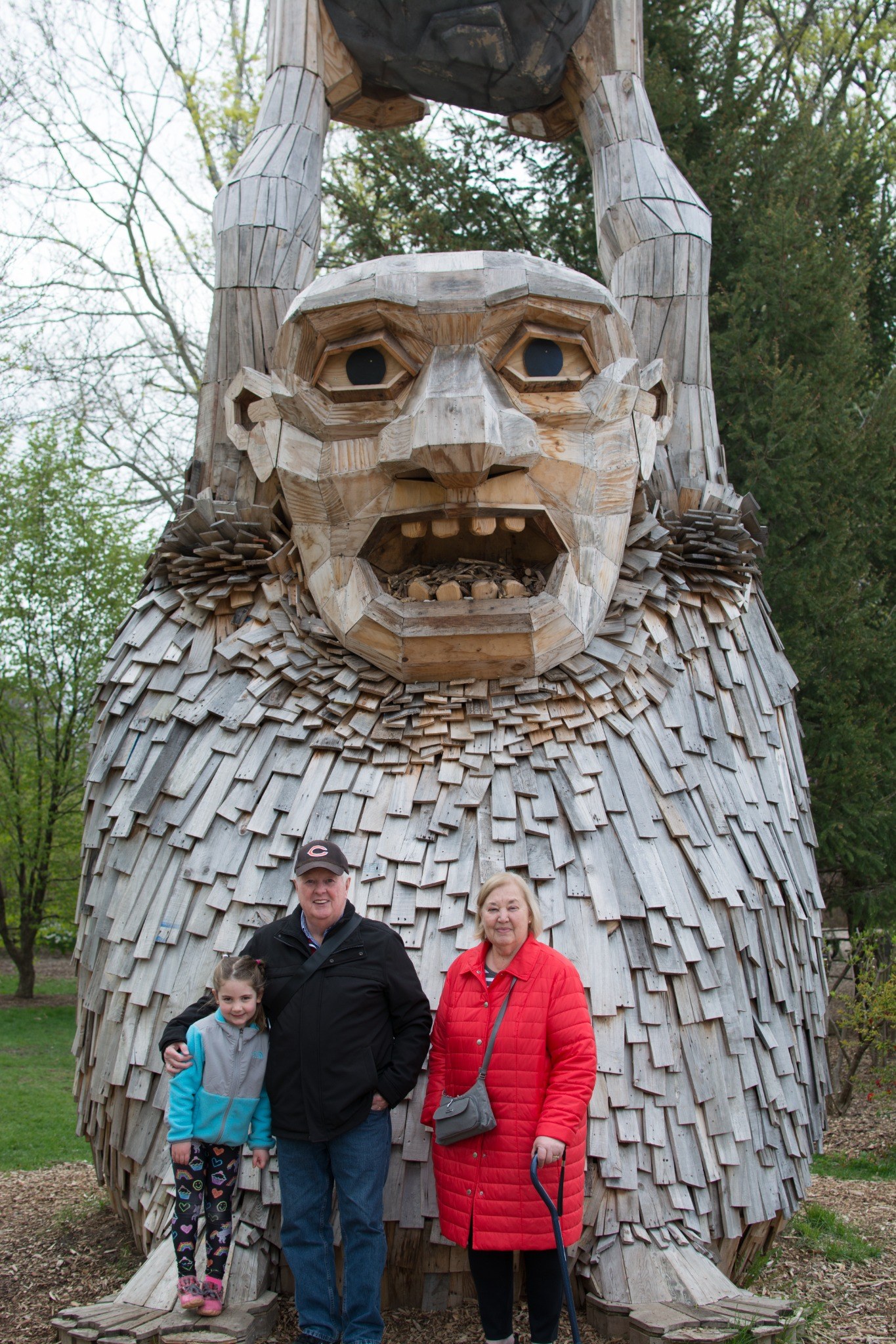 Tom and family visiting a wooden sculpture